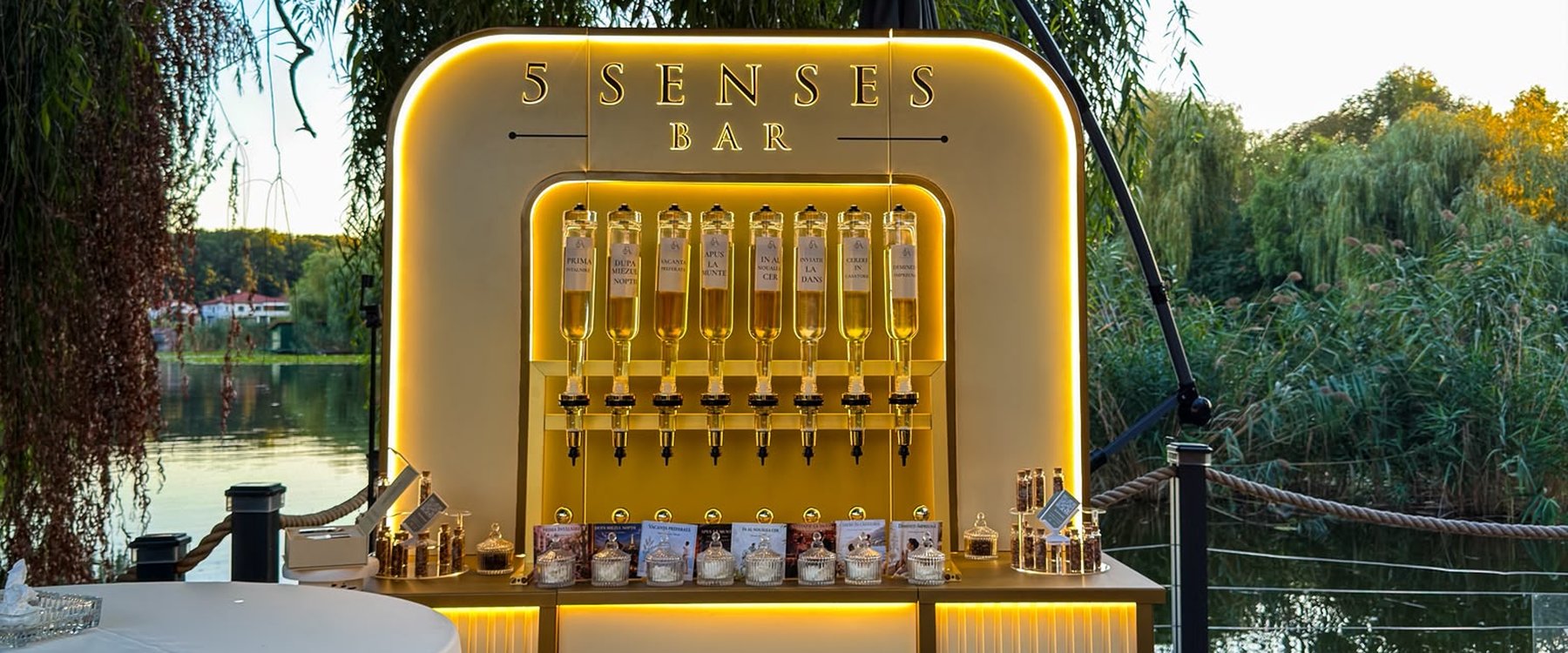 Standul 5 Senses Bar la eveniment, la malul lacului, cu sticlele de parfum luminate